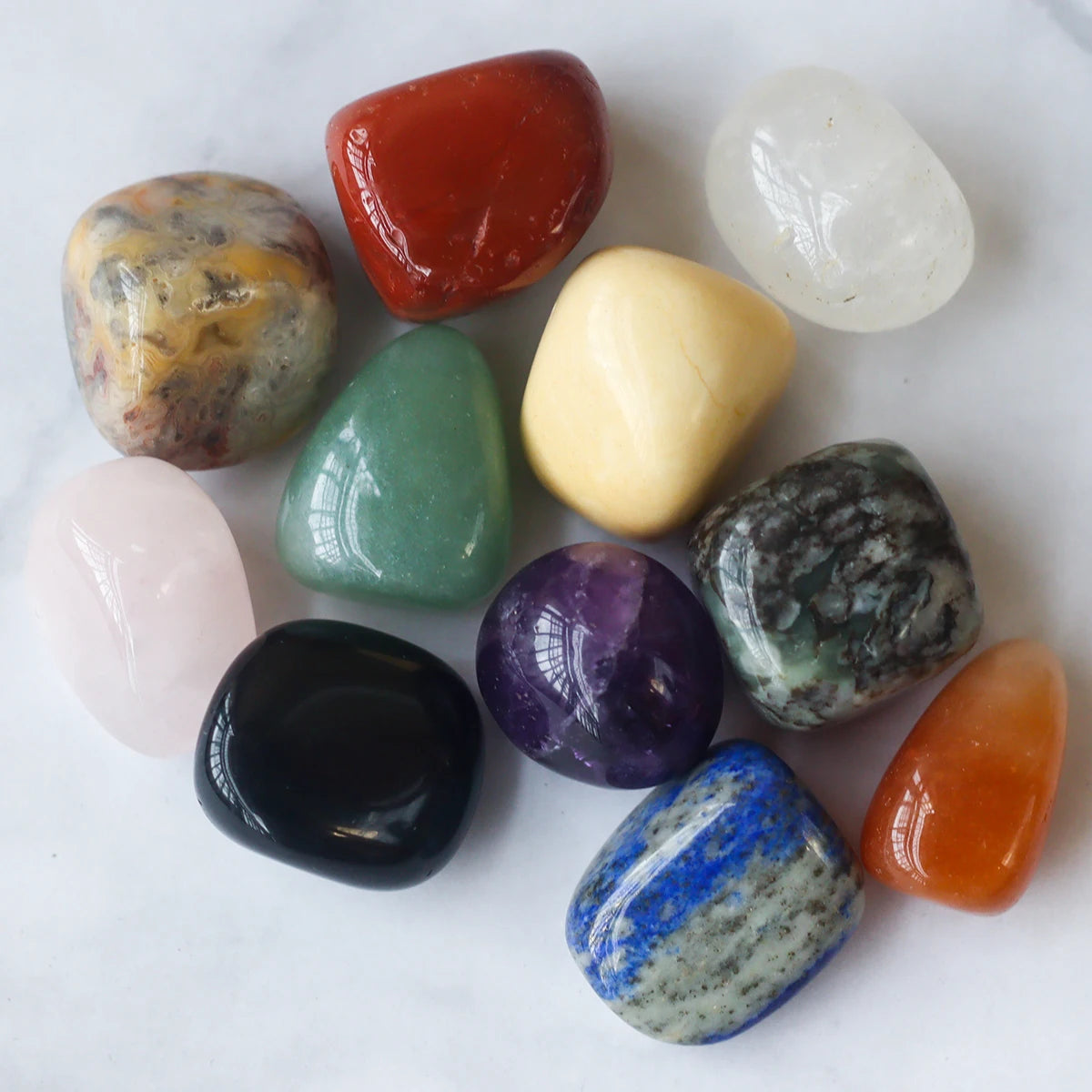 Collection of various colorful crystals on a white background