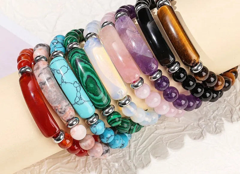 Colorful beaded bracelets on a textured surface