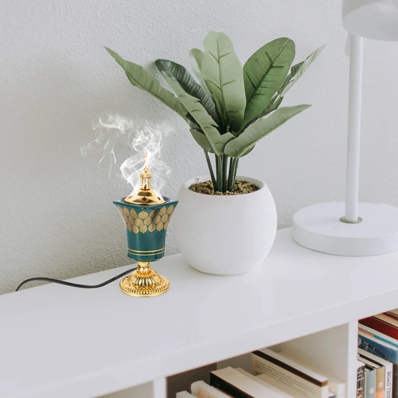 Decorative lamp with gold accents on a white surface next to a potted plant.