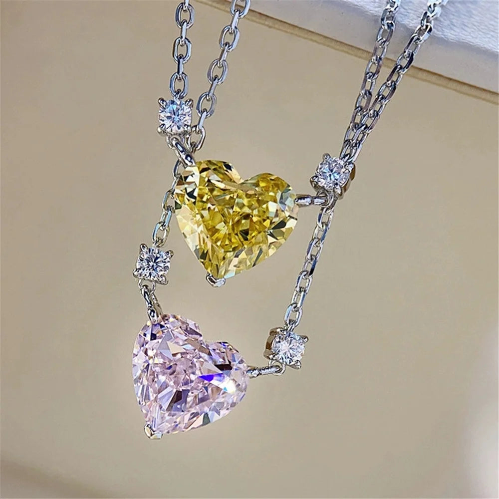 Necklace with heart-shaped diamond pendants on a beige background
