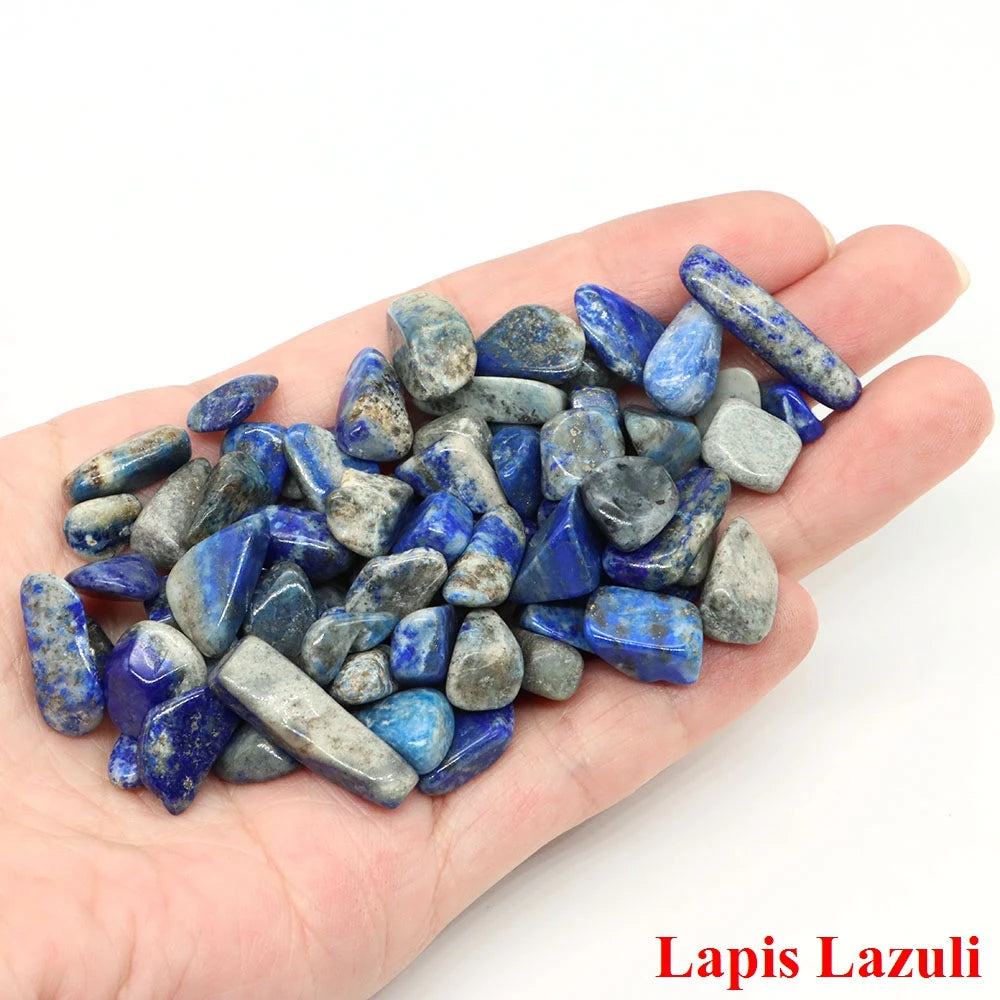 Hand holding a collection of Lapis Lazuli stones on a white background