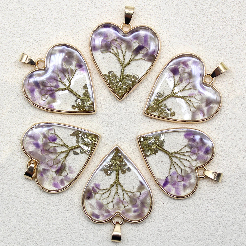 Set of heart-shaped pendants with floral designs on a light background