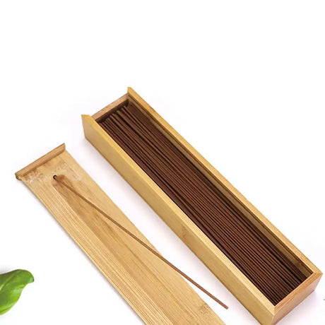 Bamboo incense box with incense sticks on a white background