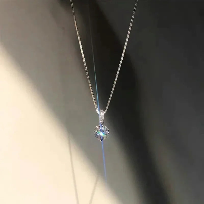 Silver necklace with a sparkling pendant on a dark background