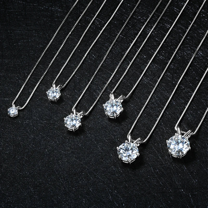Silver necklaces with diamond pendants on a black background