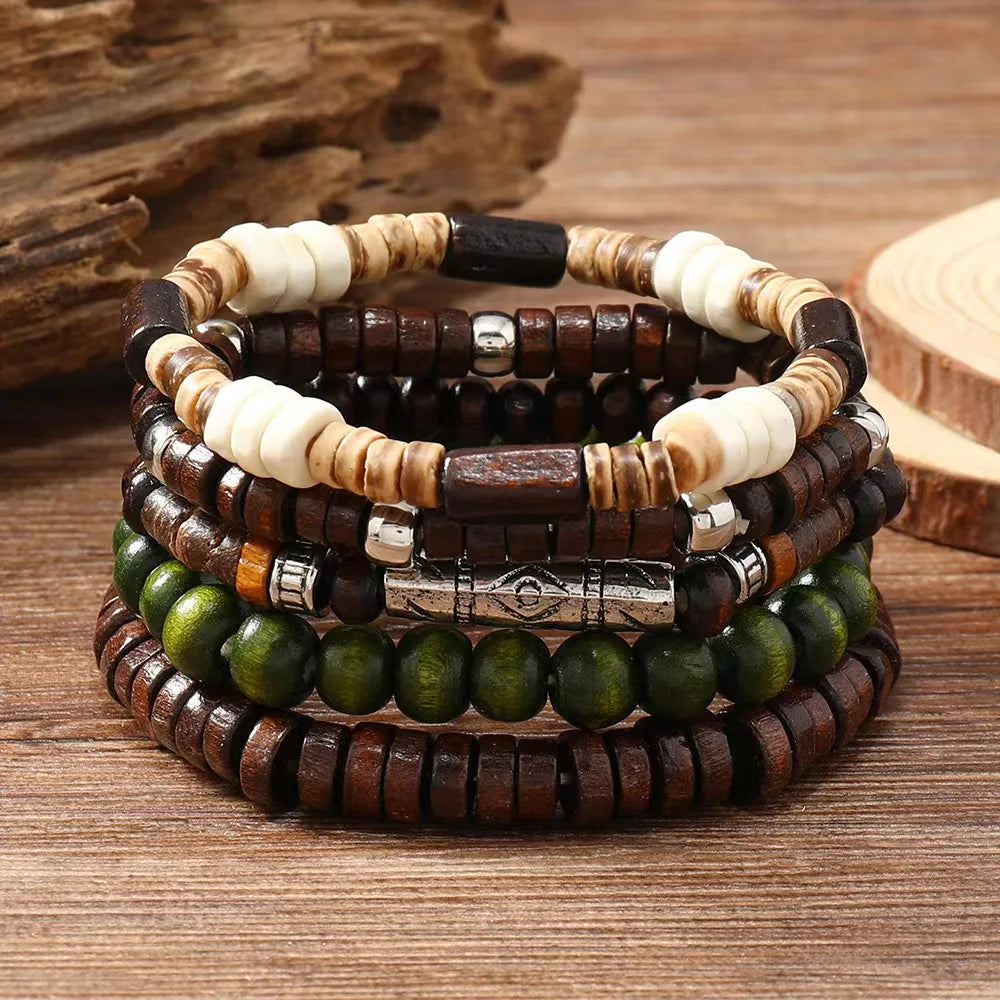 Stack of wooden and beaded bracelets on a wooden surface