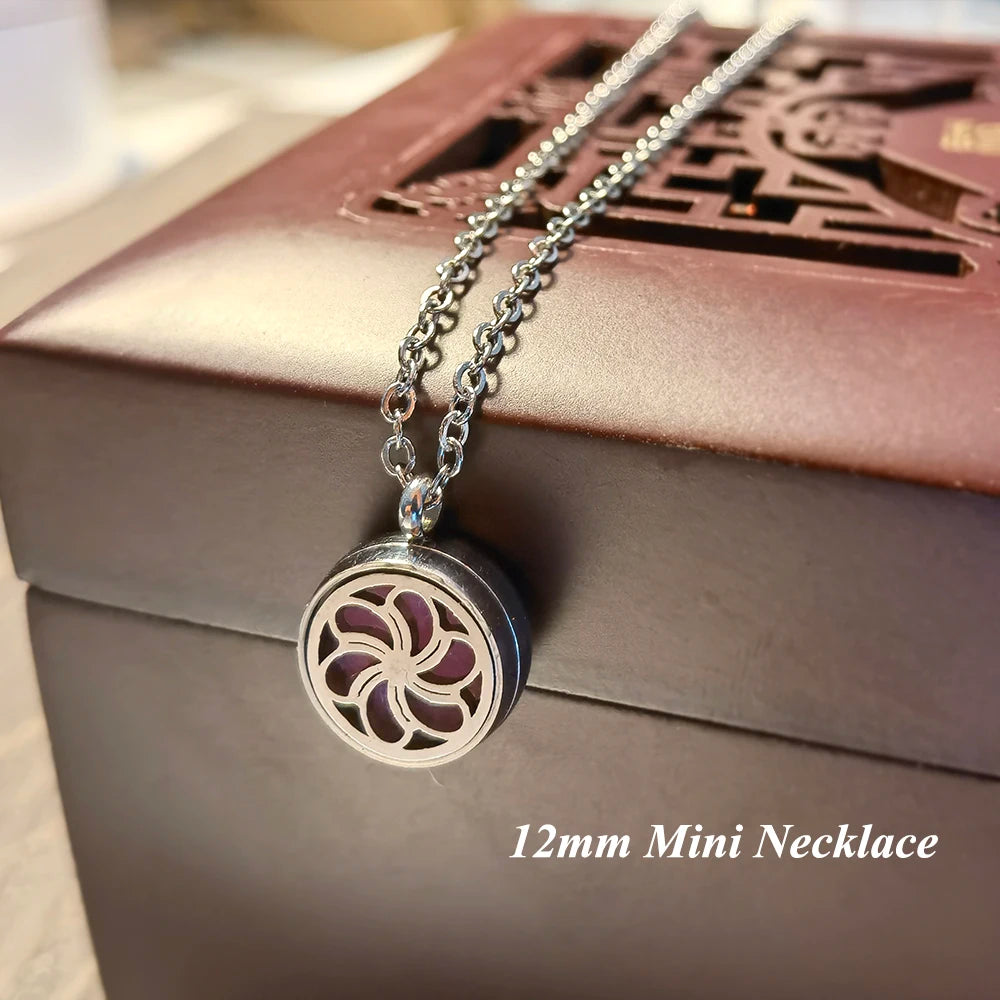 Silver 12mm mini necklace with decorative pendant on a brown box.