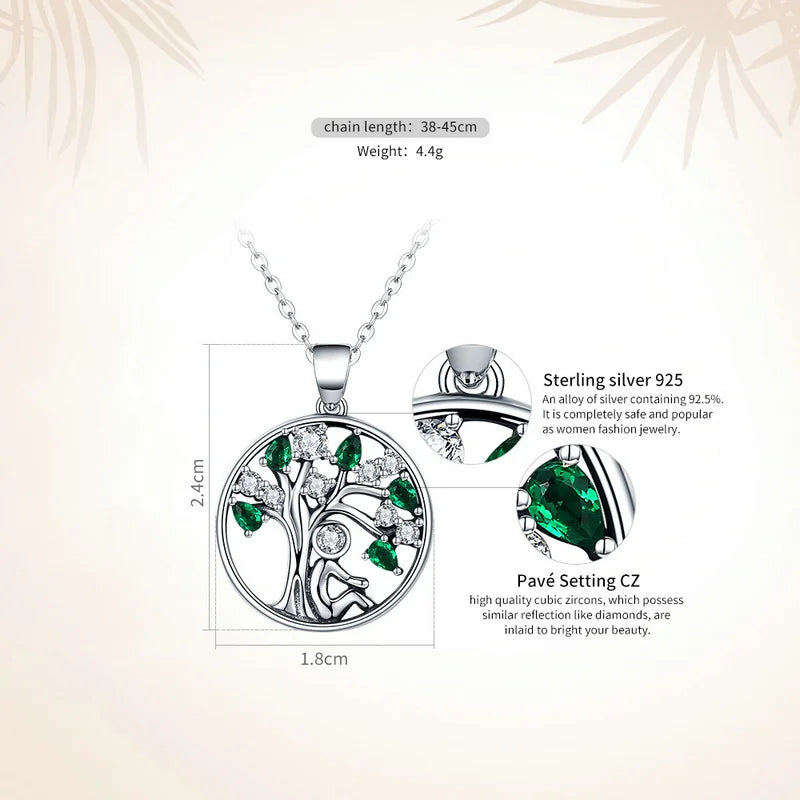 Silver necklace with green gemstone pendant on a light background