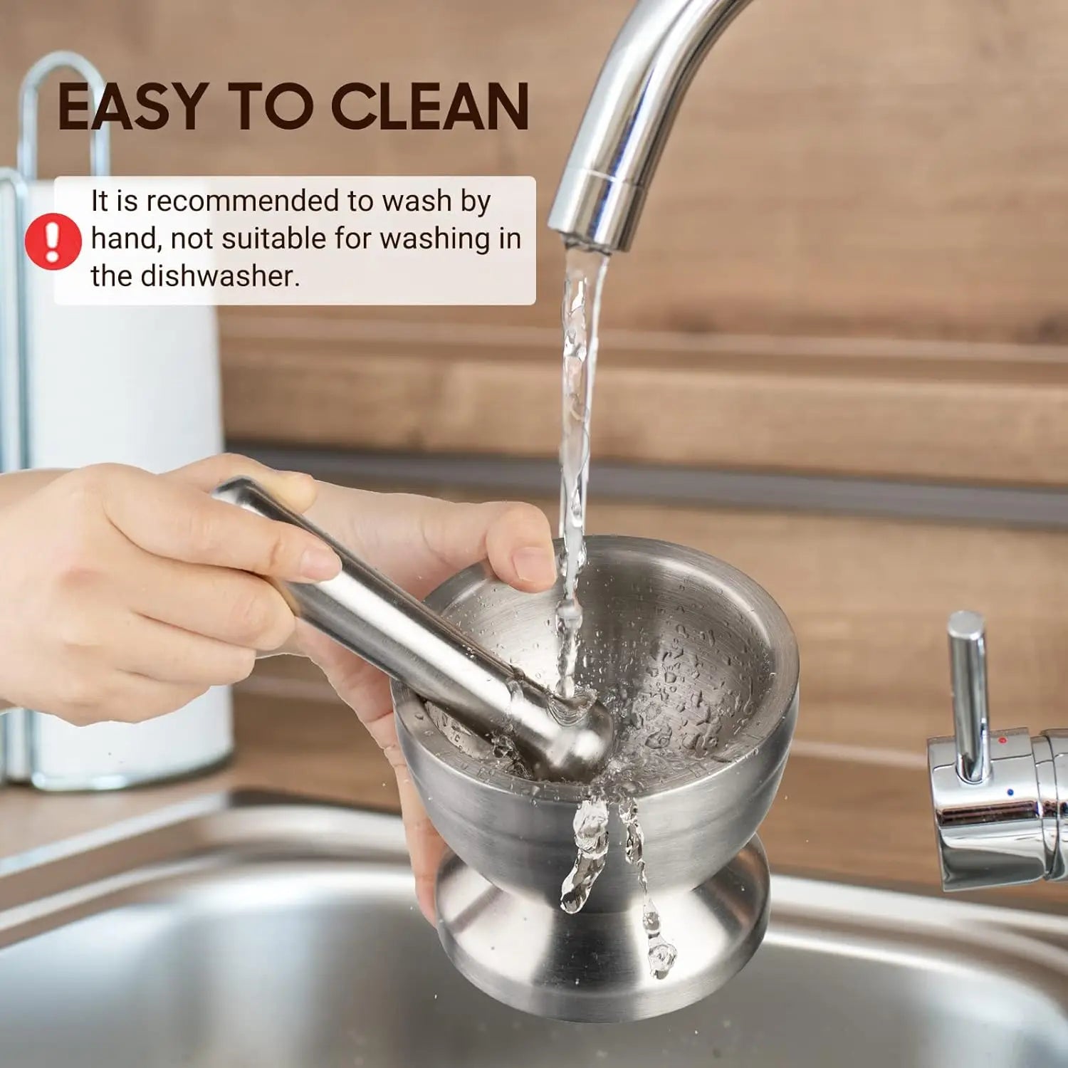 Person washing a metal strainer under running water with text about cleaning instructions.
