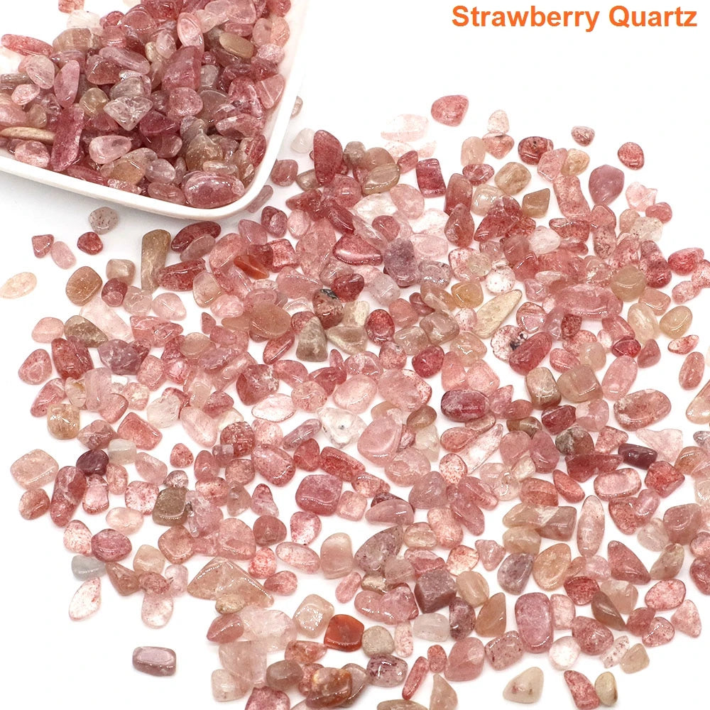 Strawberry quartz stones with a bowl of stones on a white background
