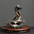 Decorative incense burner with a lotus flower and hands on a dark background