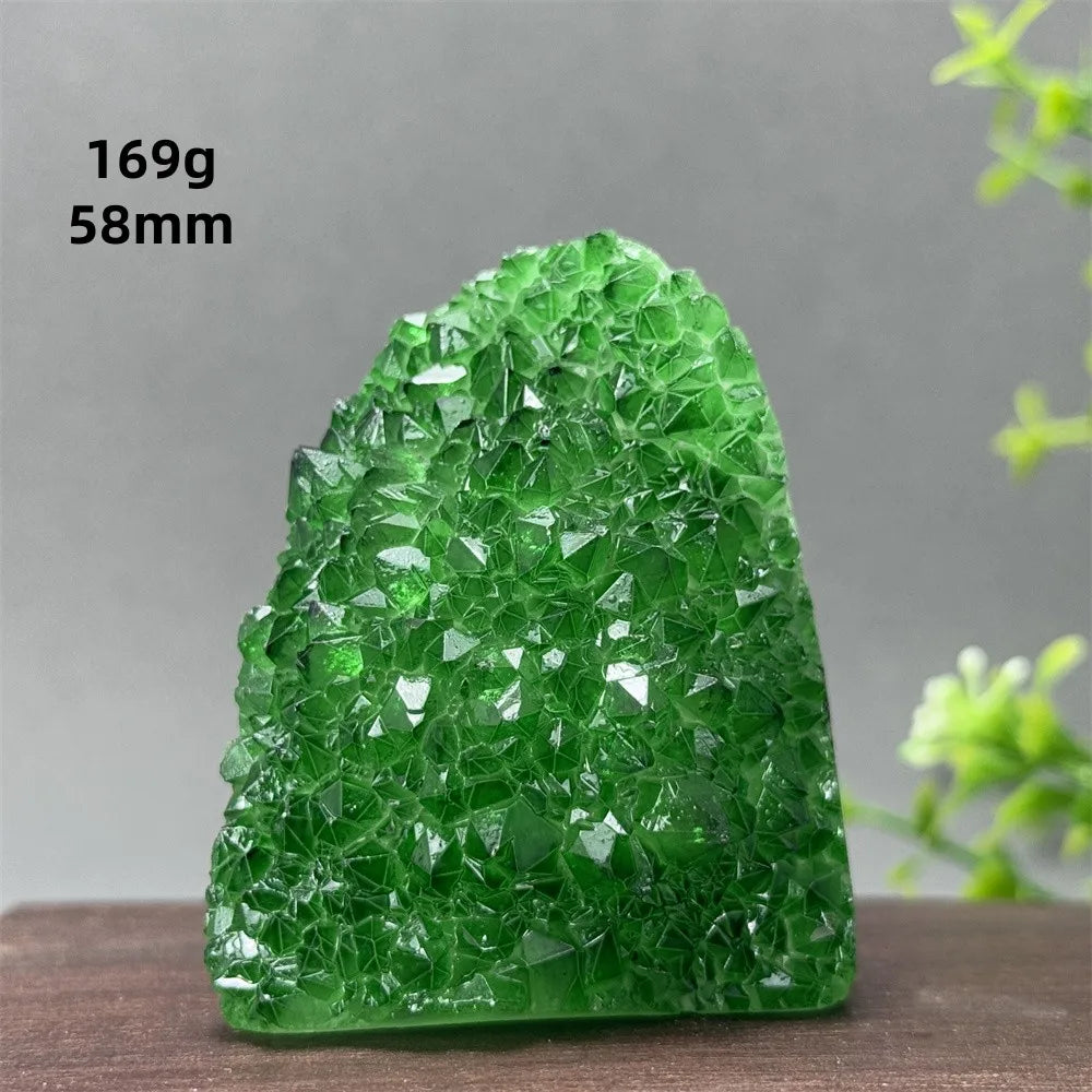 Green crystal rock on a wooden surface with a gray background
