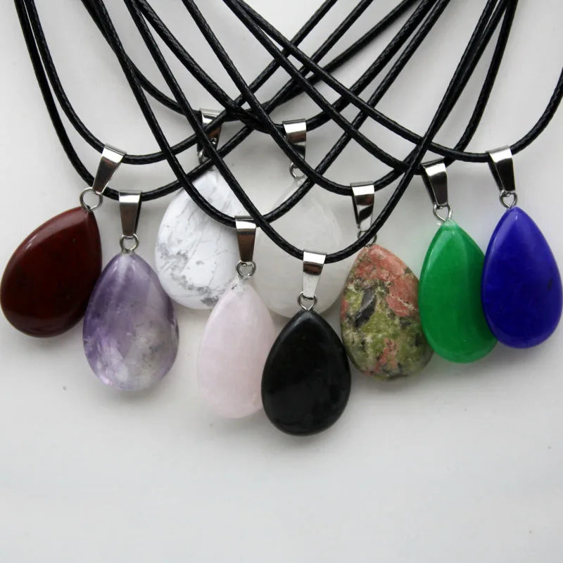 Necklaces with various colored teardrop pendants on a white background