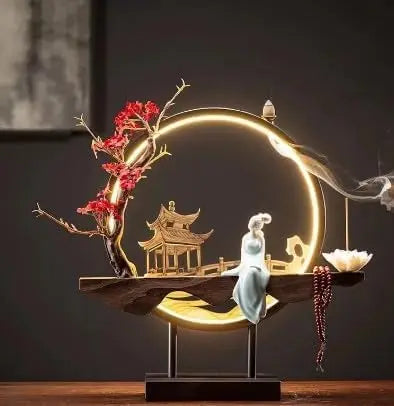 Decorative scene with a pagoda, person, and tree on a dark background