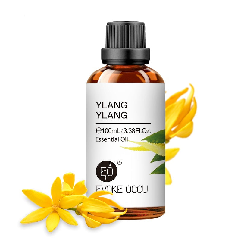 Ylang ylang essential oil bottle with flowers on a white background, featuring Evoke Occu branding.