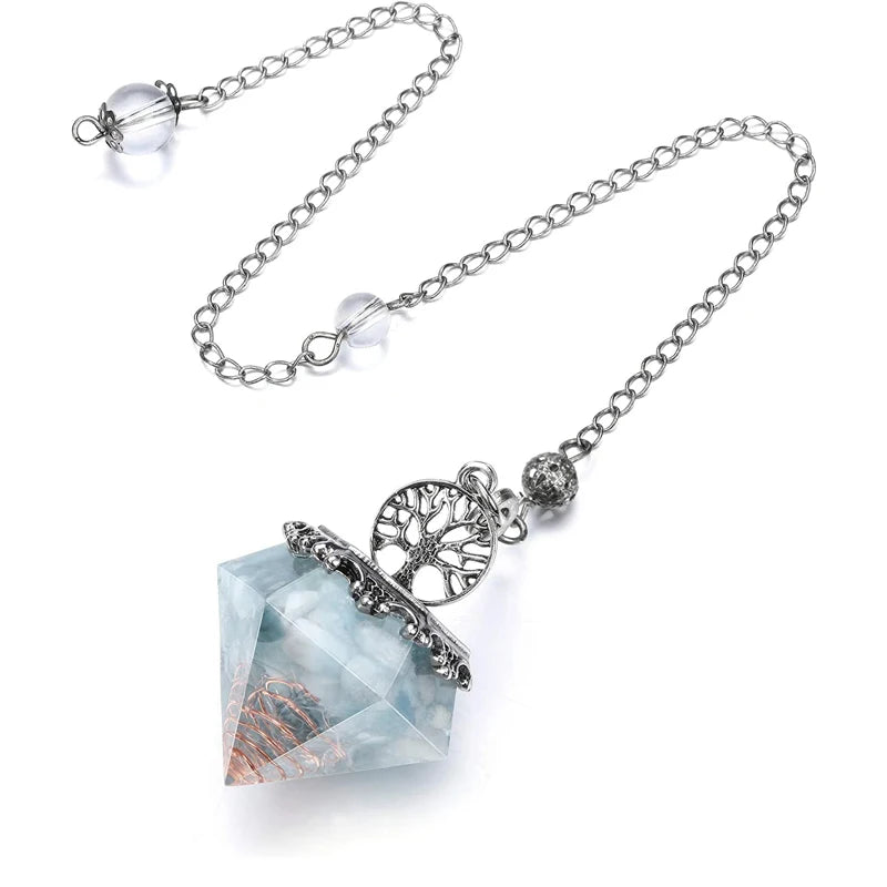 Necklace with a crystal pendant and tree of life charm on a white background