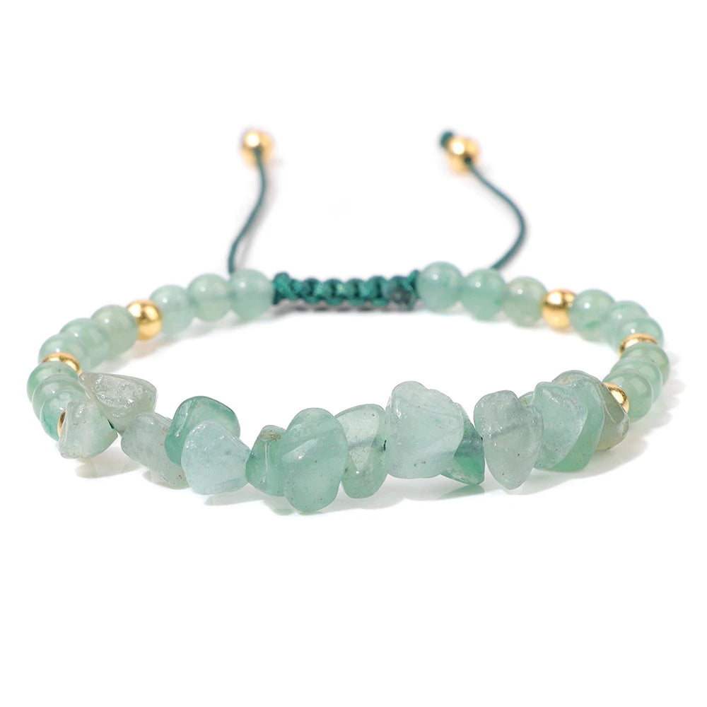 Green beaded bracelet with gold accents on a white background