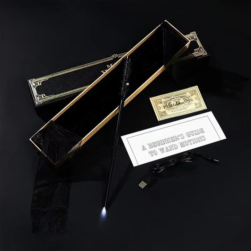 Wand with a light on a black background, accompanied by a book titled 'A Beginner's Guide to Wand Magic' and a small gold object.