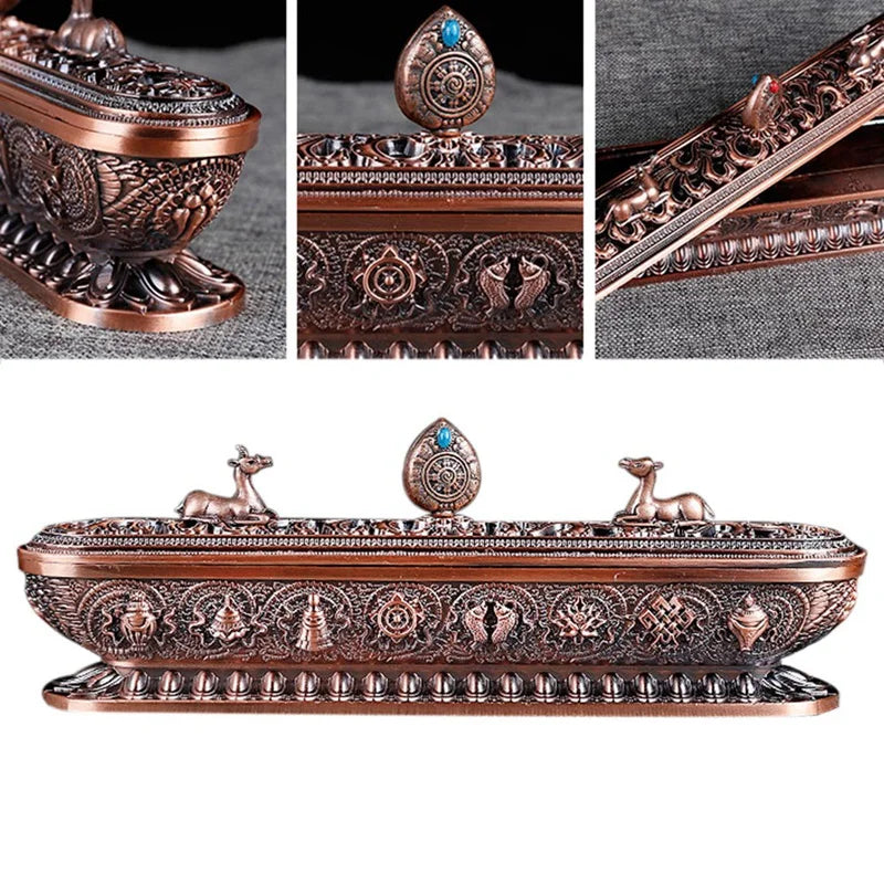Decorative copper box with intricate designs and small figures on a white background