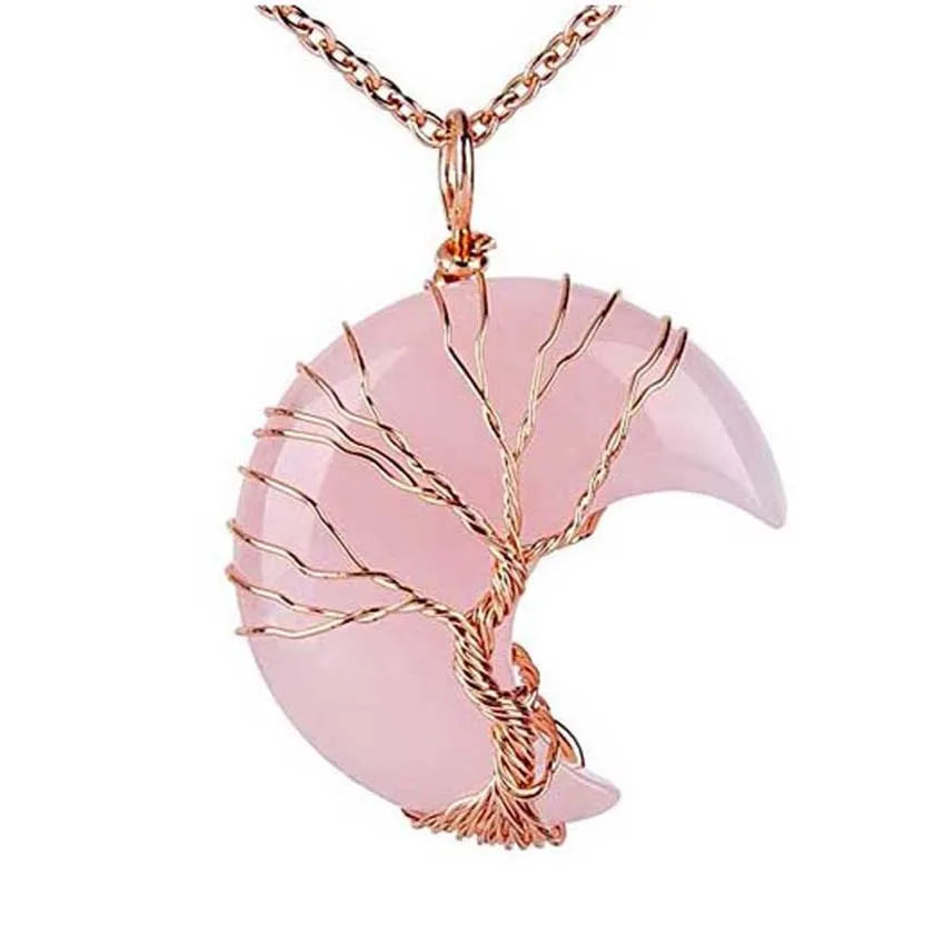 Pink crescent moon pendant with gold wire wrapping on a white background