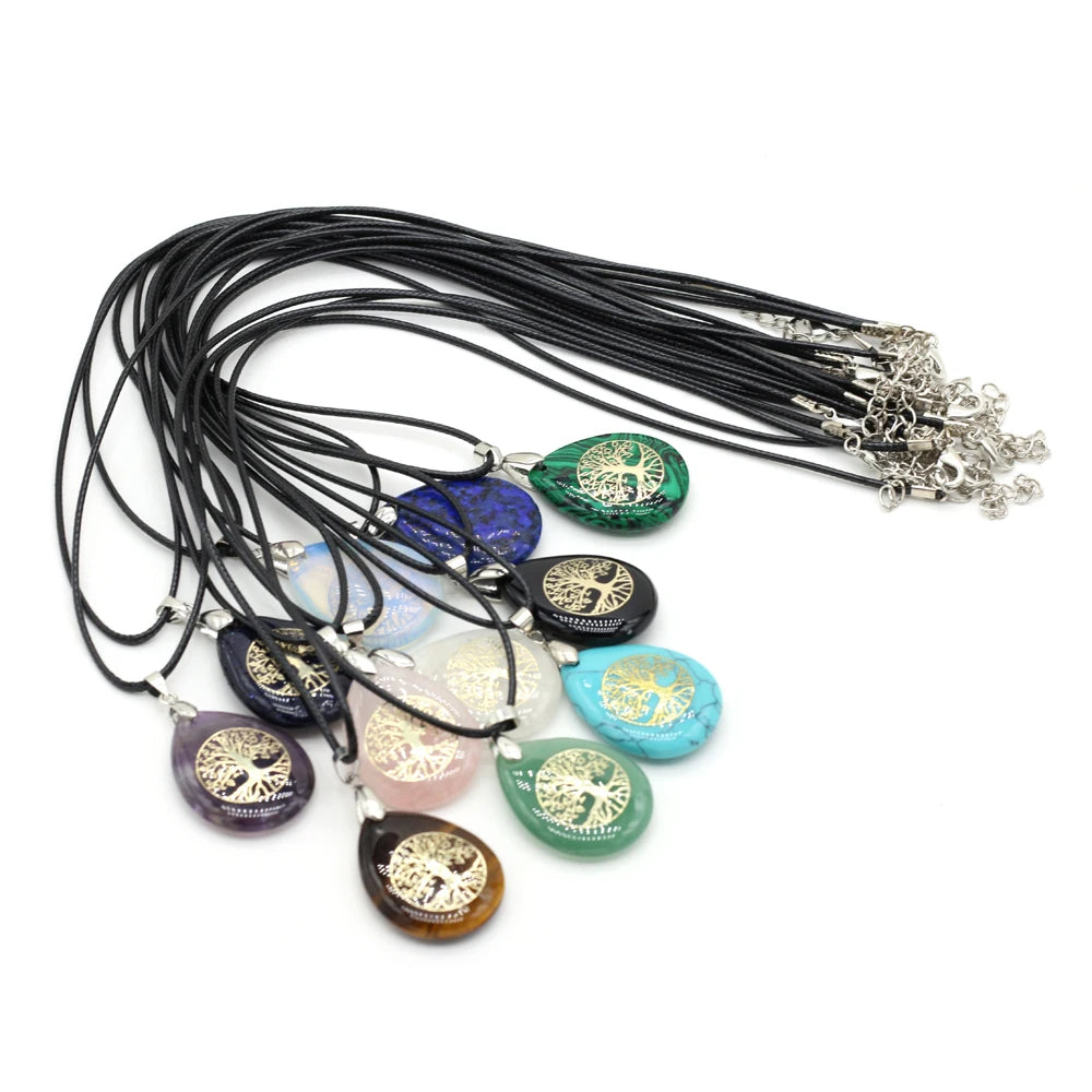 Set of tree-of-life pendants on black cords with a white background