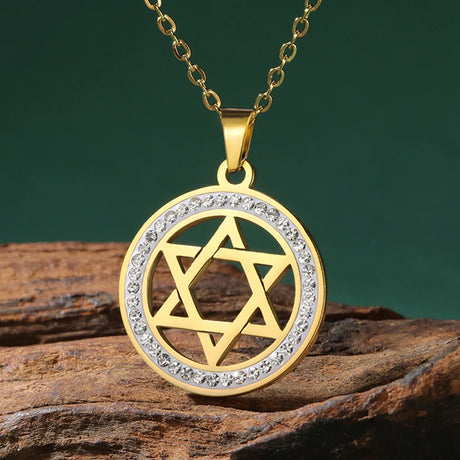 Gold pendant with Star of David design on a wooden surface