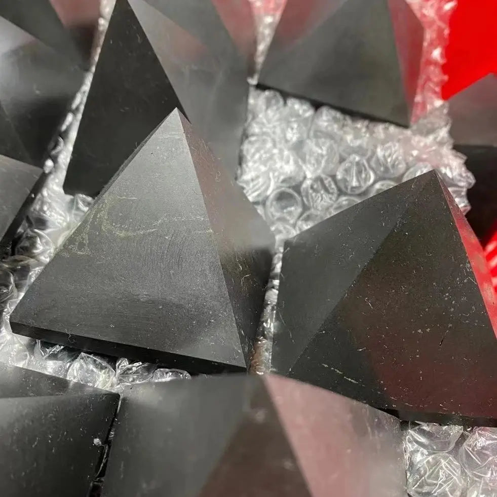 Close-up of black triangular objects on a reflective surface