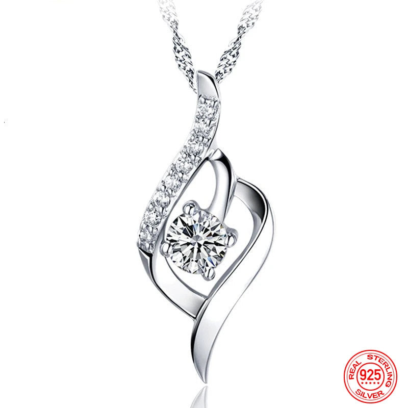 Silver necklace with a heart-shaped pendant and diamond on a white background, featuring the brand 'ZDADAN'.
