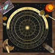Astrological chart with celestial symbols on a wooden surface with candles and crystals.