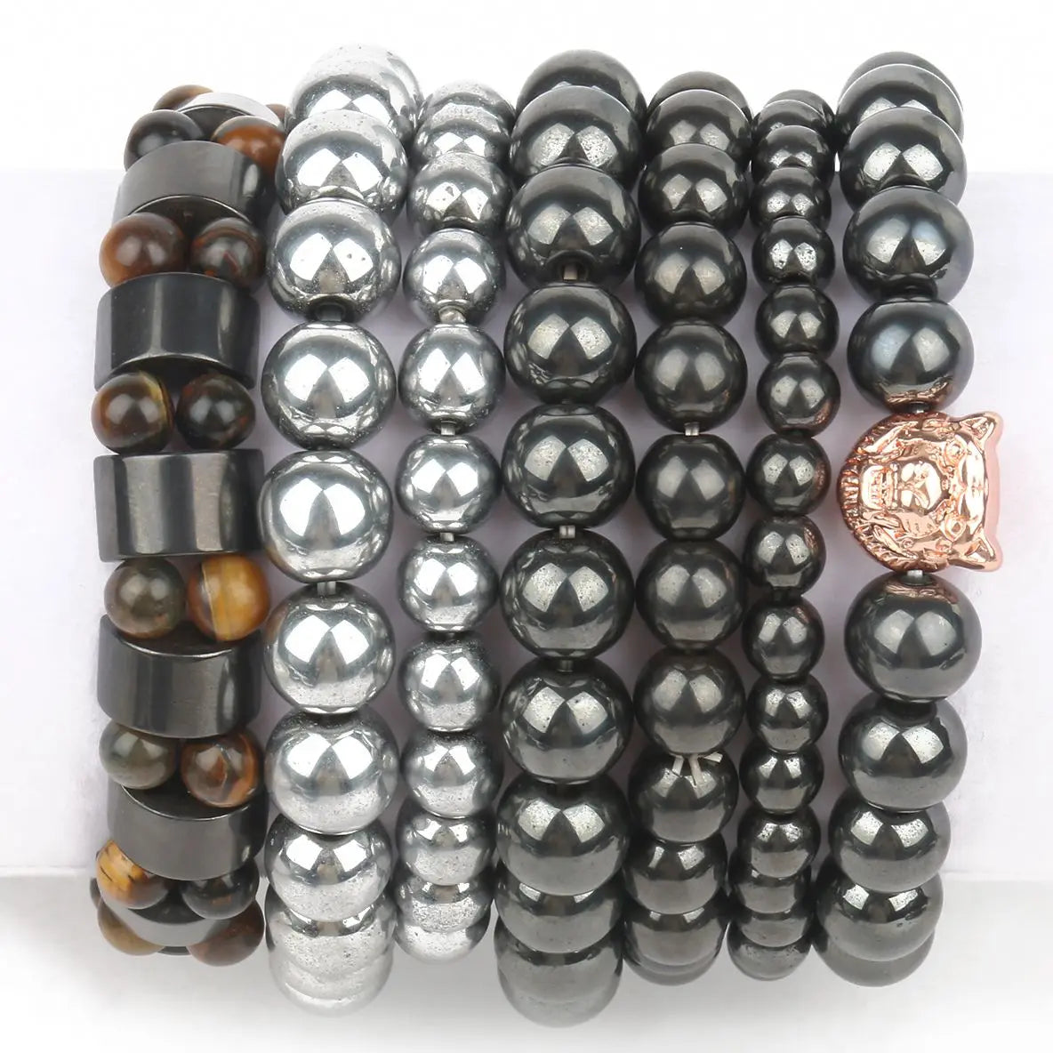 Set of beaded bracelets with black, silver, and rose gold accents on a white background