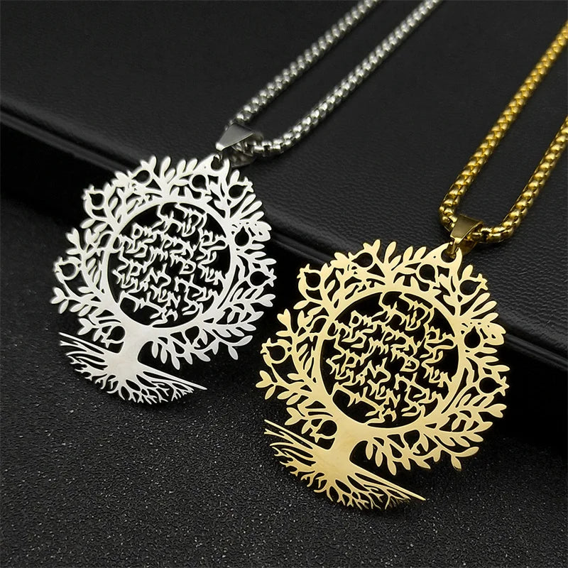 Two tree-shaped pendants, one gold and one silver, on a black background.