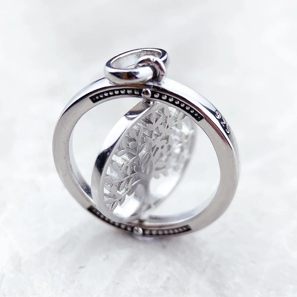 Silver ring with intricate design on a white background