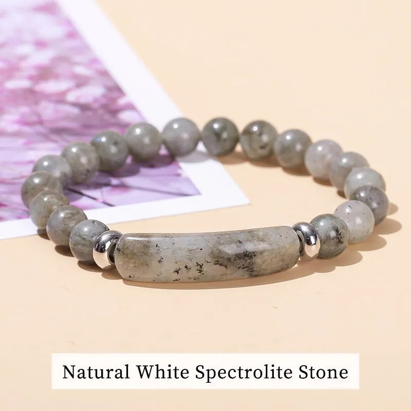 Necklace with natural white spectrolite stone on a beige background