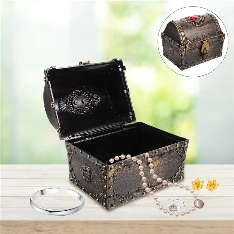 Decorative jewelry box with a close-up inset, placed on a wooden surface with jewelry items around.