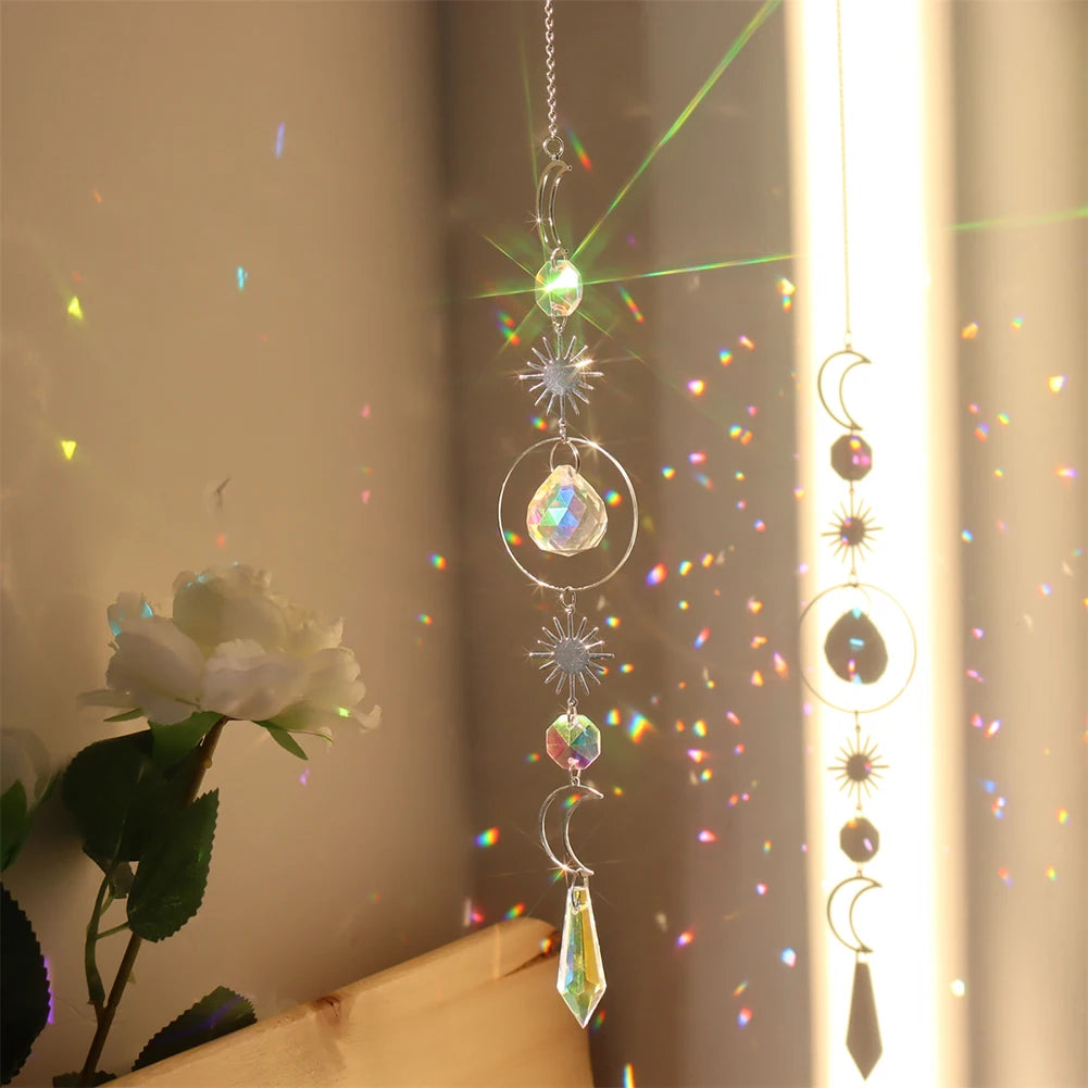 Decorative hanging crystal with rainbow, held against a neutral background.