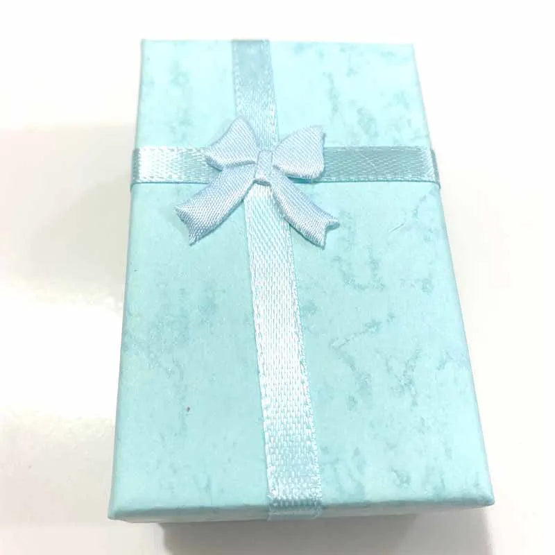 Light blue gift box with a white ribbon on a white background
