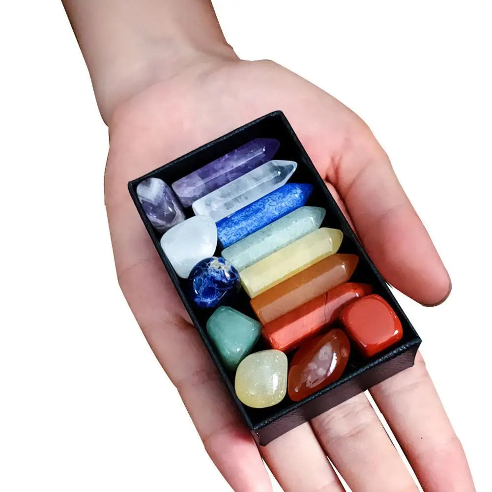 Hand holding a box of colorful crystals on a white background