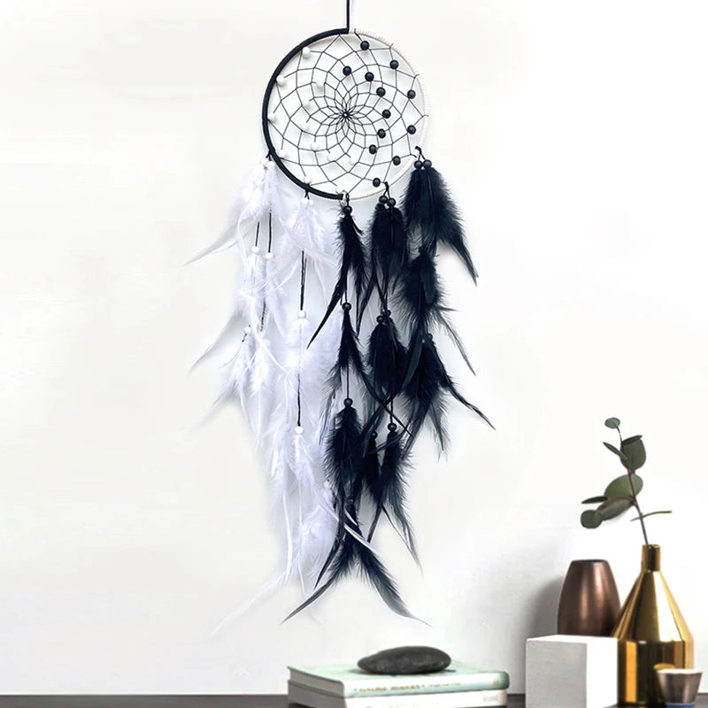Black and white dreamcatcher with feathers on a white background
