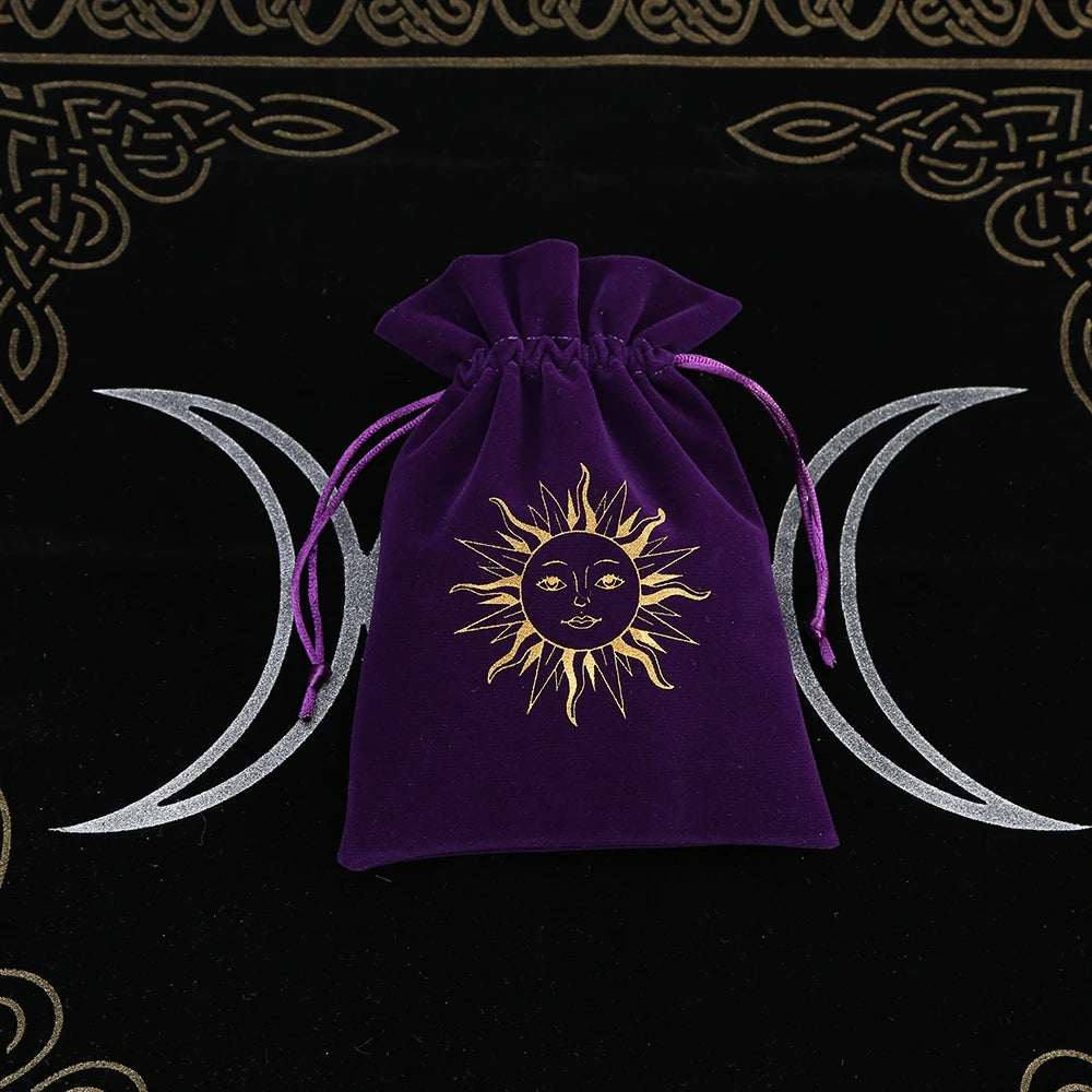 Purple drawstring bag with sun and moon design on a black background with wiccan symbols.