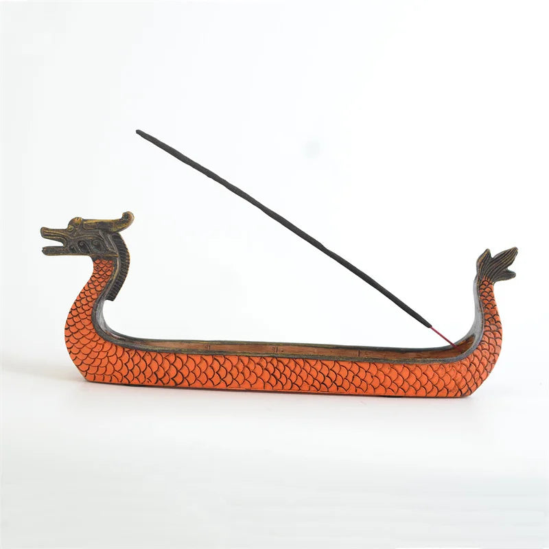 Dragon boat incense burner with a single incense stick on a white background