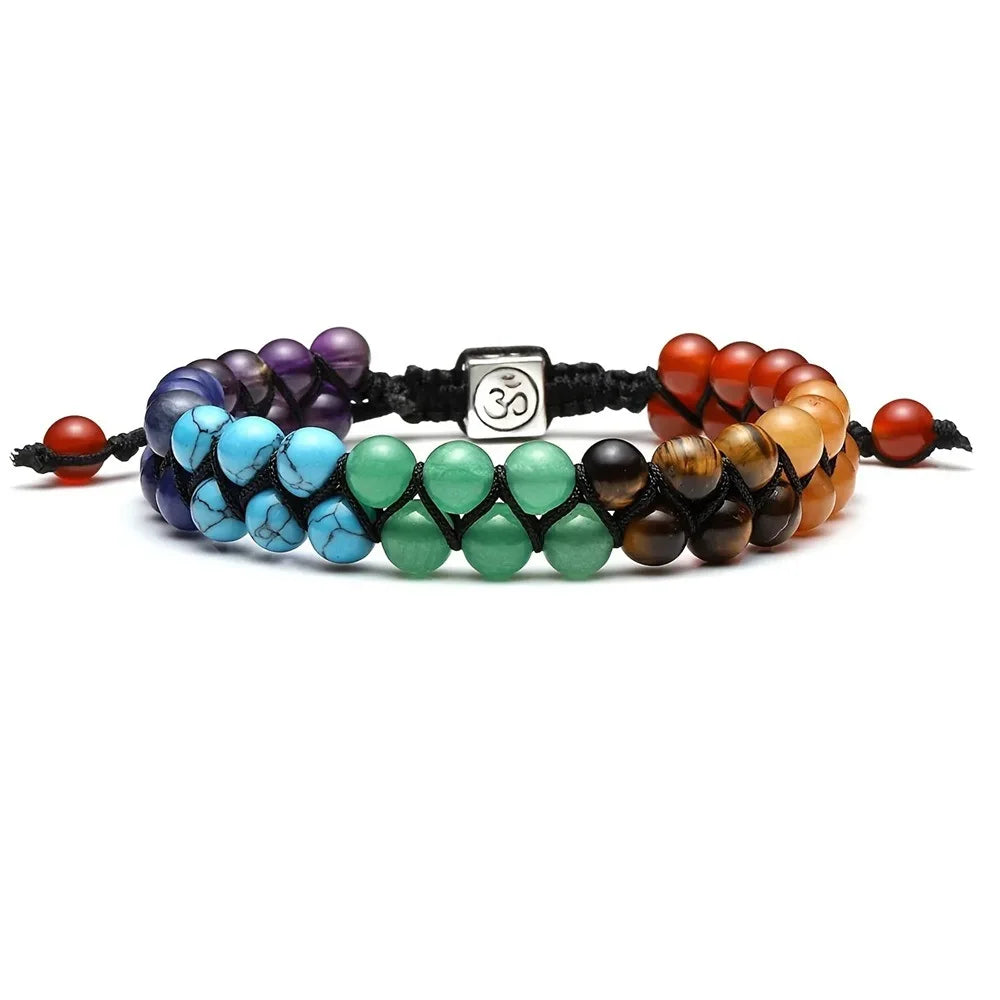 Multicolored beaded bracelet with a central OM symbol charm on a white background
