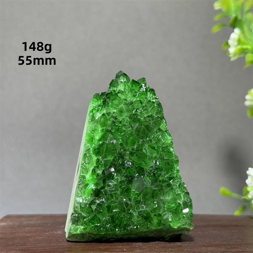 Green crystal on a wooden surface with a gray background