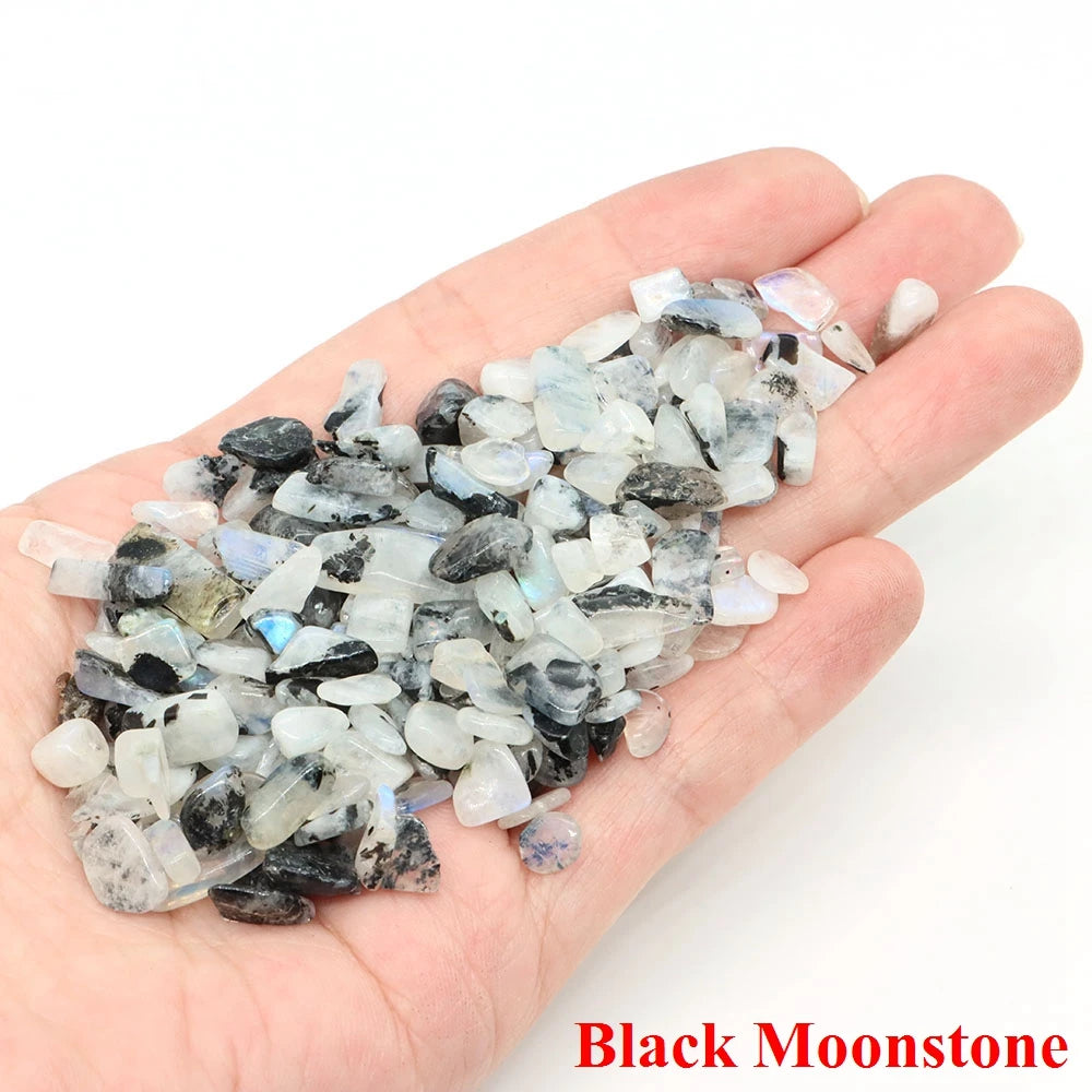 Hand holding a pile of black moonstone crystals with 'Black Moonstone' text.