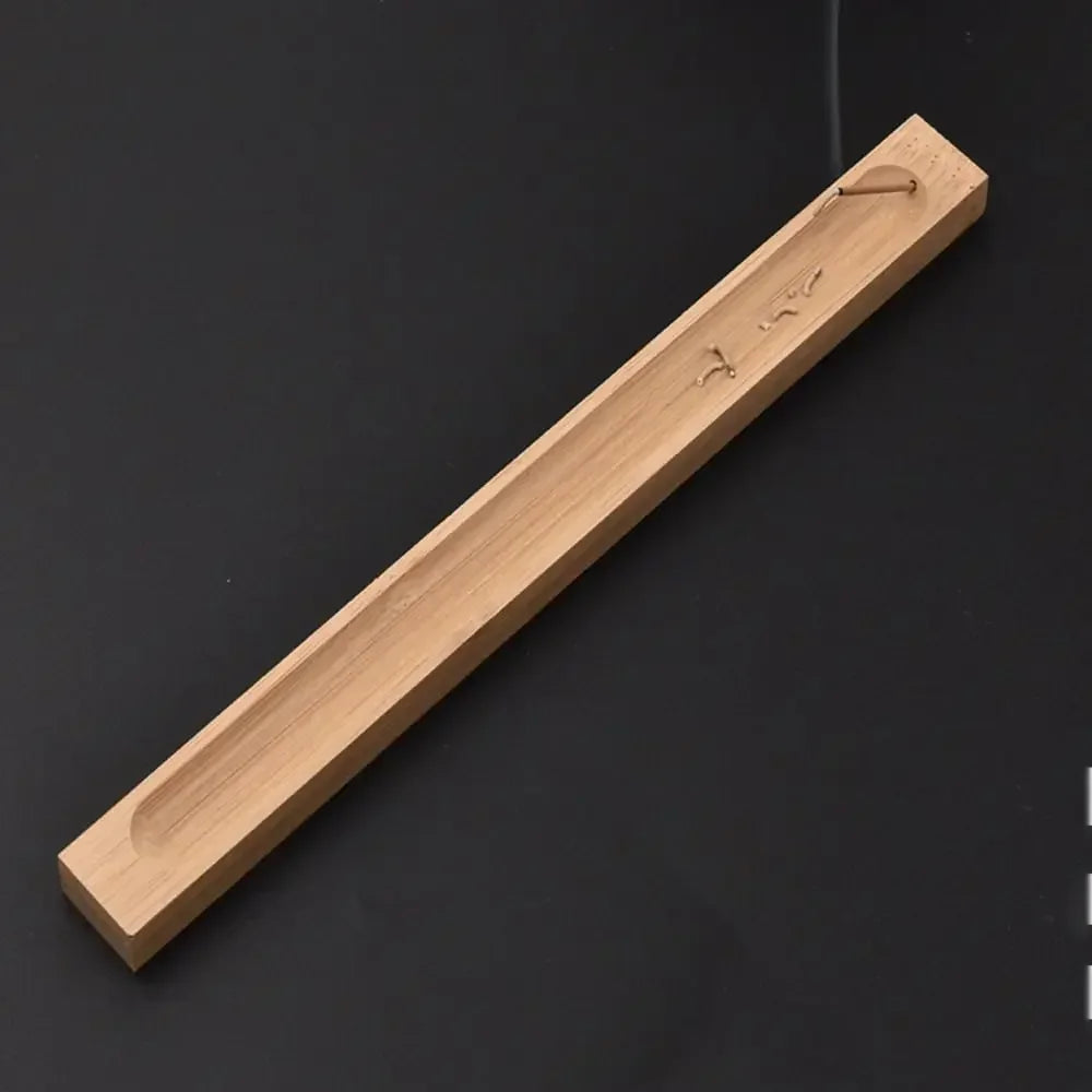Wooden incense stick holder on a black background
