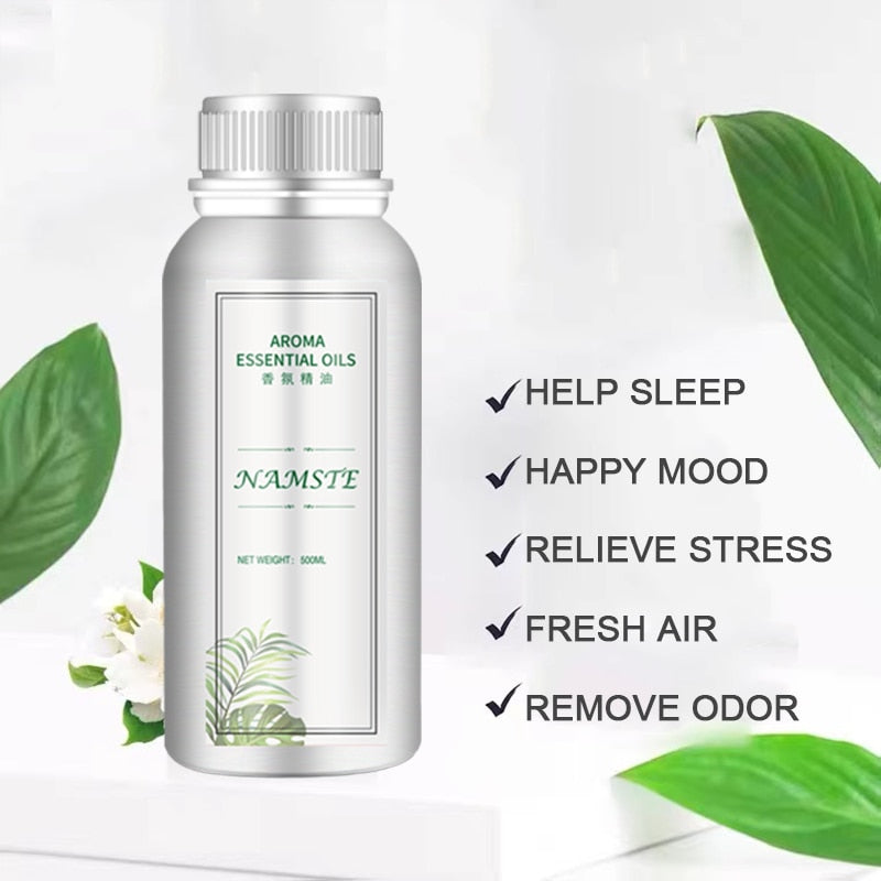 Aroma essential oils bottle with green leaves on a white background