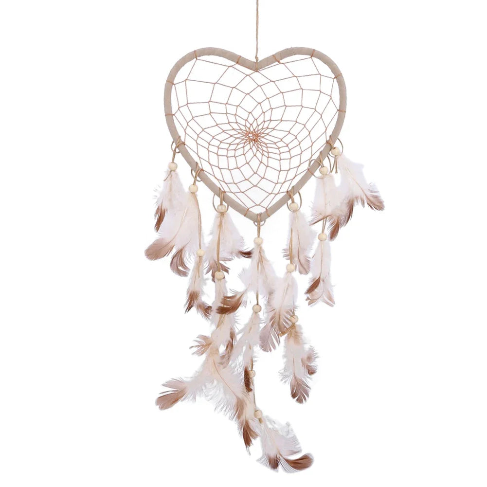 Heart-shaped dreamcatcher with feathers on a white background