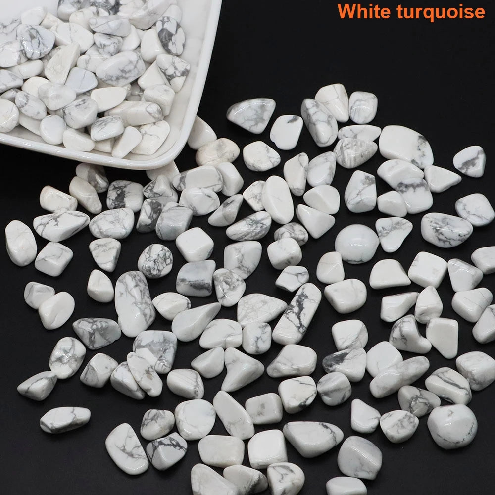 White turquoise stones with a white container on a black background