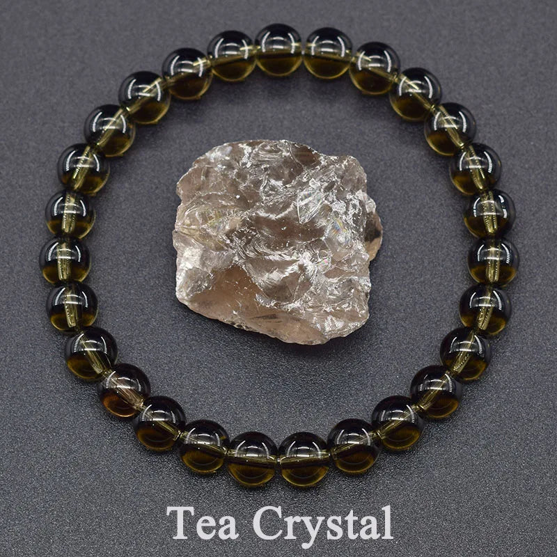 Tea crystal bracelet with a rough crystal on a gray background