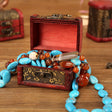 Decorative jewelry box with beads on a wooden surface