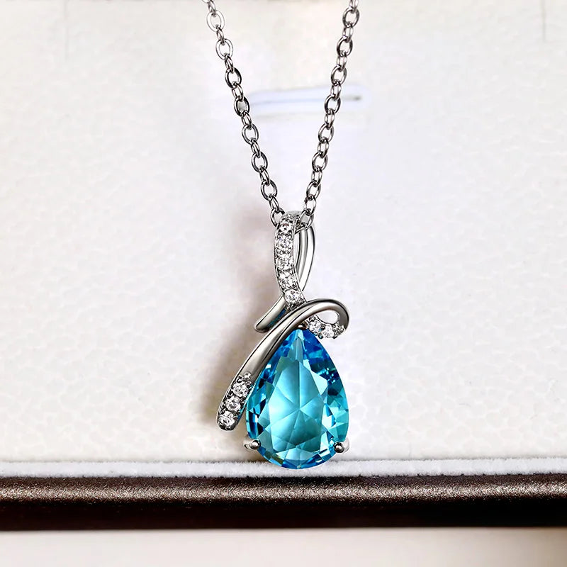 Blue teardrop pendant necklace on a white background